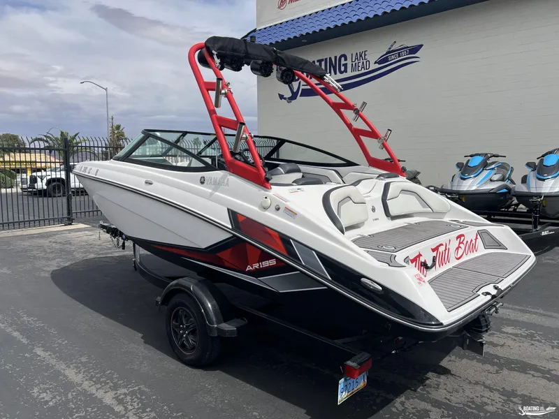Slide: The Image of 2018 Yamaha AR195 boat with red accents parked at Lake Mead dealership. - 2