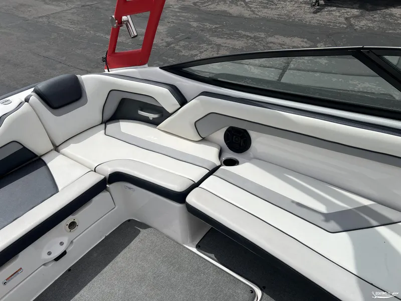 Slide: The Image of 2018 Yamaha AR195 boat interior with white seating and speaker. - 9