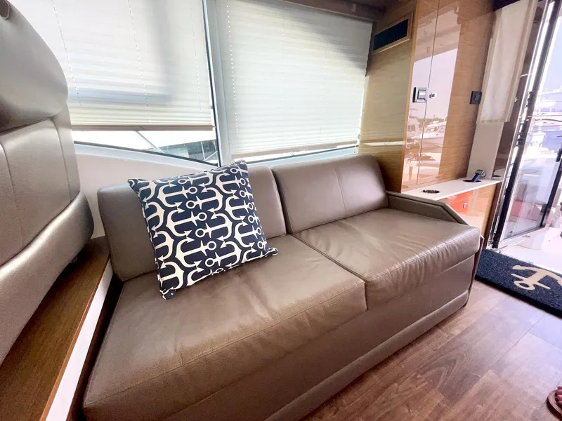 Slide: The Image of Luxurious interior of 2018 Cruisers 45 Cantius yacht with leather sofa and decorative pillow. - 11