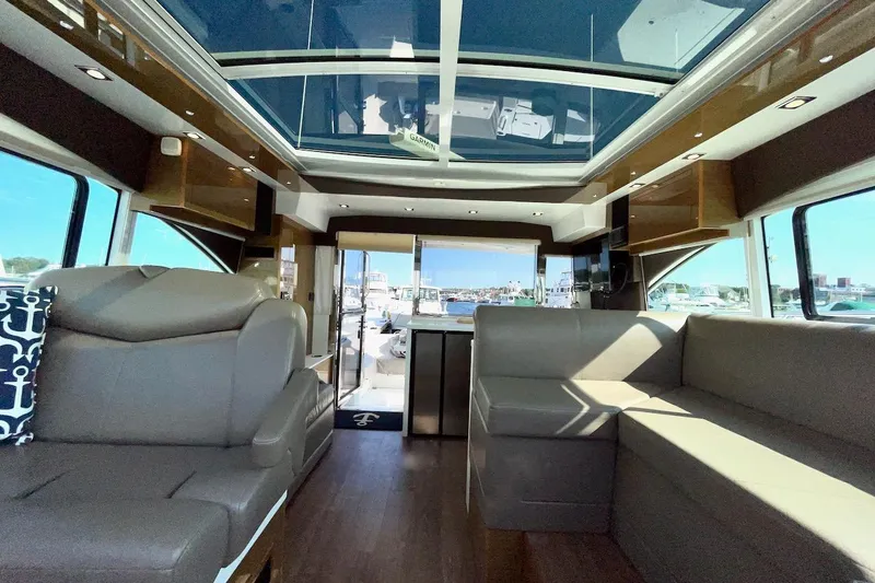 Slide: The Image of Luxurious interior of 2018 Cruisers Yachts 45 Cantius with panoramic windows and plush seating. - 2