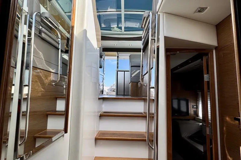 Slide: The Image of Interior view of 2018 Cruisers Yachts 45 Cantius, featuring wooden stairs and modern design. - 26