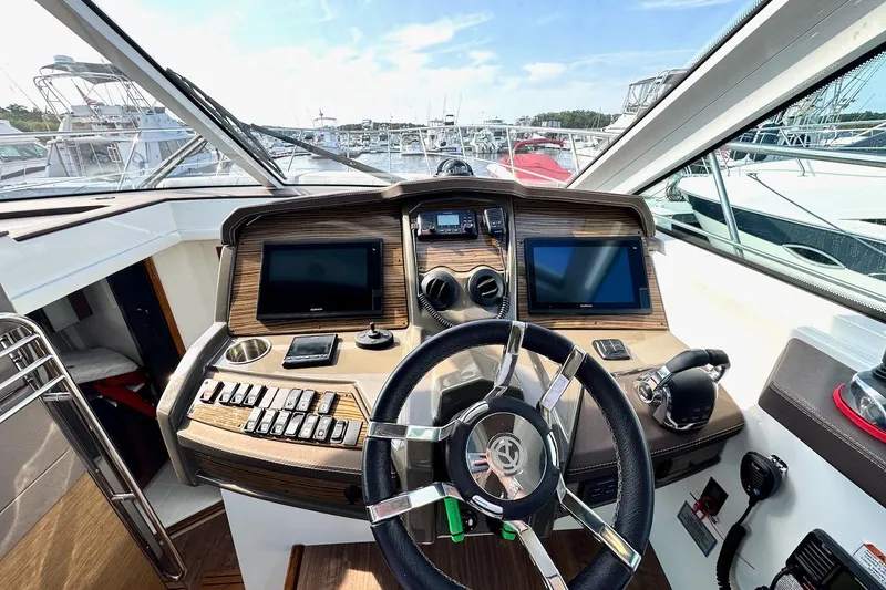 Slide: The Image of 2018 Cruisers Yachts 45 Cantius helm with dual screens and modern controls. - 33