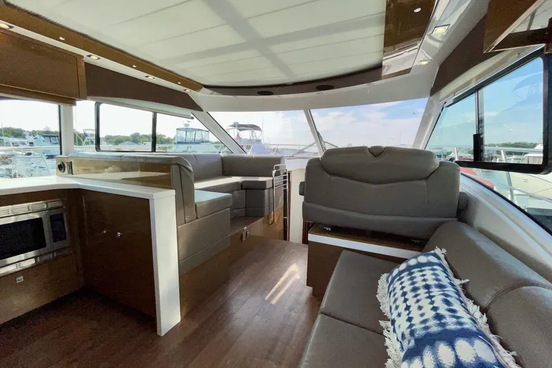 Slide: The Image of Luxurious interior of 2018 Cruisers Yachts 45 Cantius with modern seating and panoramic windows. - 5