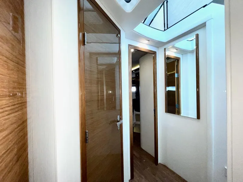 Slide: The Image of Interior hallway of 2018 Cruisers 45 Cantius yacht with wooden doors and skylight. - 50