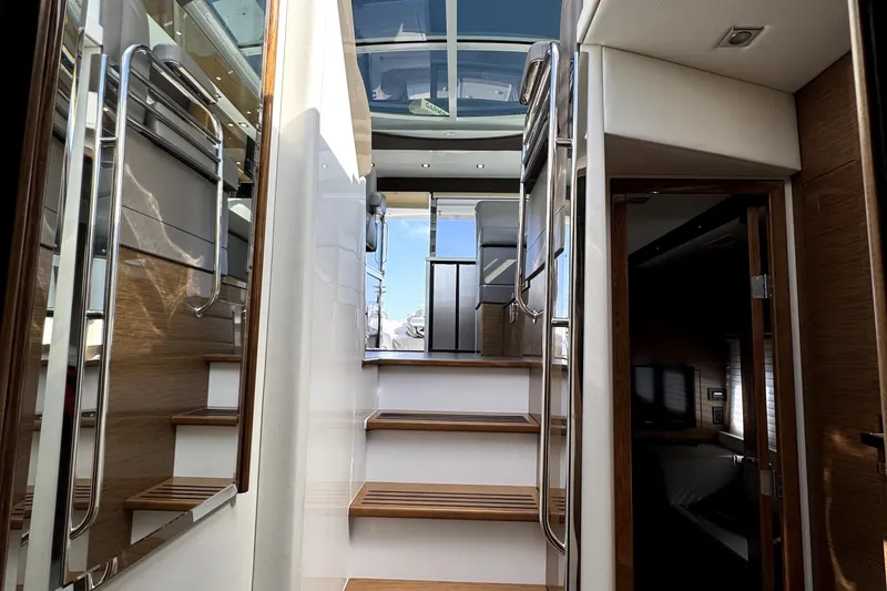 Slide: The Image of Interior view of 2018 Cruisers Yachts 45 Cantius with wooden stairs and modern design. - 59