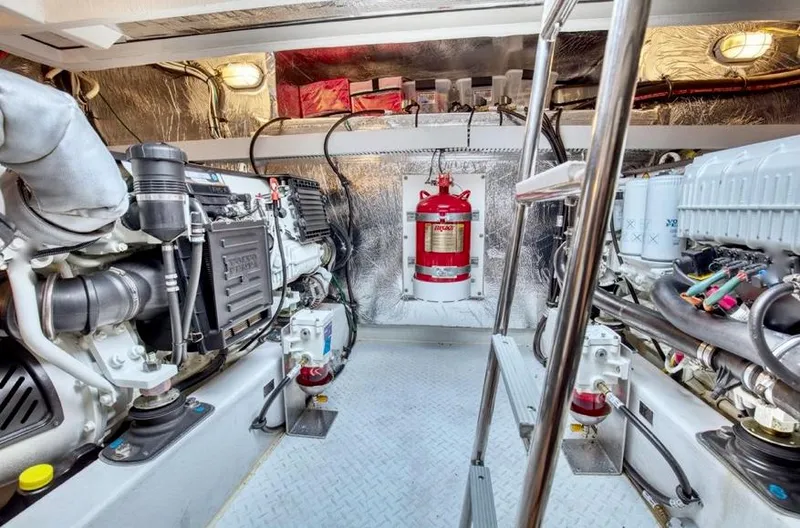 Slide: The Image of Engine room of 2018 Cruisers 45 Cantius yacht, featuring modern equipment and fire extinguisher. - 61