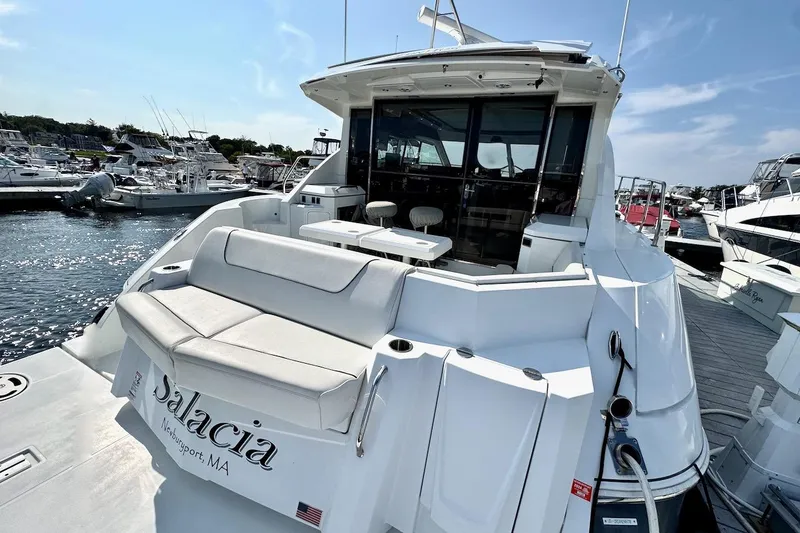 Slide: The Image of 2018 Cruisers Yachts 45 Cantius docked, featuring spacious seating and sleek design. - 73