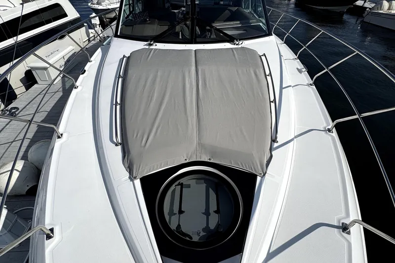 Slide: The Image of 2018 Cruisers Yachts 45 Cantius deck with sunpad and hatch, docked at marina. - 76