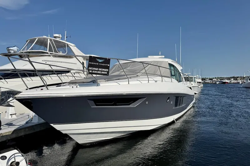 Slide: The Image of 2018 Cruisers Yachts 45 Cantius docked at marina under clear blue sky. - 77