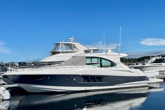 Slide: The Image of 2018 Cruisers Yachts 45 Cantius docked, sleek design, blue sky background. - 79