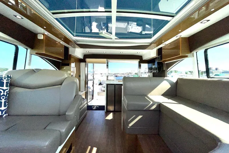 Slide: The Image of Luxurious interior of 2018 Cruisers Yachts 45 Cantius with modern seating and panoramic windows. - 8