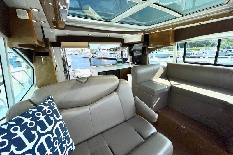 Slide: The Image of Luxurious interior of 2018 Cruisers Yachts 45 Cantius with leather seating and marina view. - 9