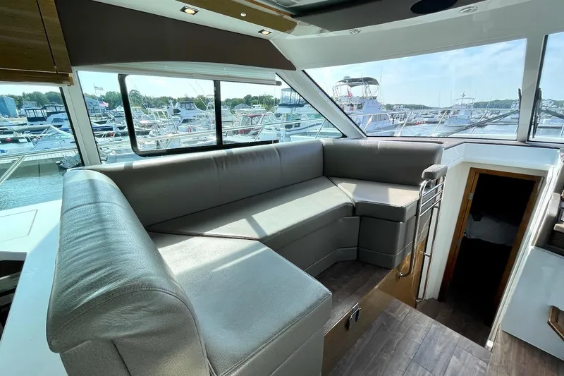 Slide: The Image of Luxurious interior of 2018 Cruisers Yachts 45 Cantius with spacious seating and marina view. - 10