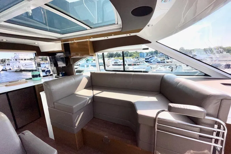 Slide: The Image of Luxurious interior of 2018 Cruisers Yachts 45 Cantius with spacious seating and panoramic windows. - 21