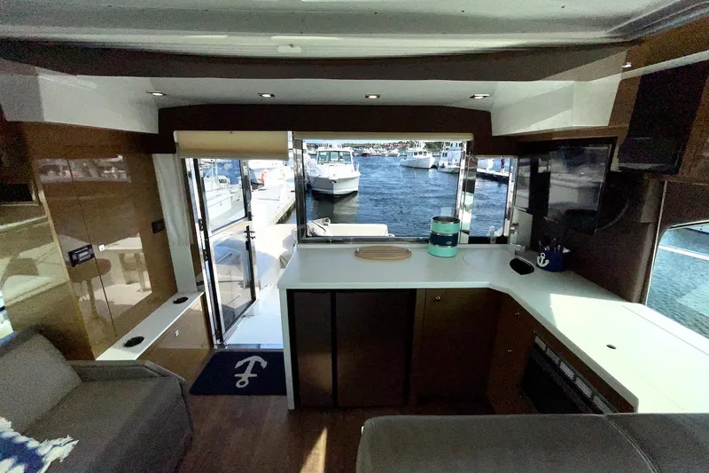 Slide: The Image of Interior view of 2018 Cruisers Yachts 45 Cantius, featuring modern design and marina backdrop. - 40