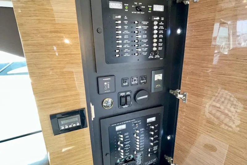 Slide: The Image of Control panel of 2018 Cruisers Yachts 45 Cantius, featuring switches and indicators. - 56