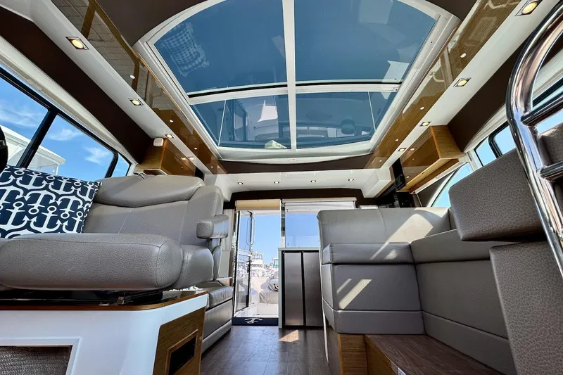 Slide: The Image of Interior of 2018 Cruisers Yachts 45 Cantius with luxurious seating and panoramic sunroof. - 57