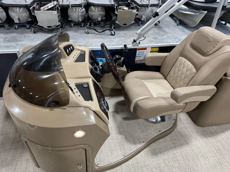 Slide: The Image of 2018 Bennington G 25 boat helm with beige captain's chair and control panel. - 10