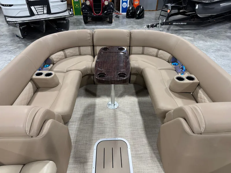 Slide: The Image of 2018 Bennington G 25 boat interior with beige seating and central table. - 11