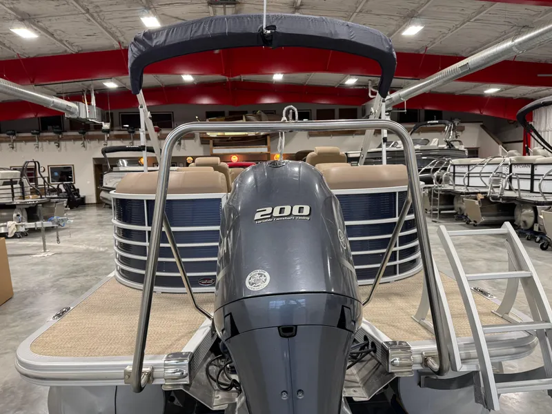 Slide: The Image of 2018 Bennington G 25 pontoon boat with 200 horsepower engine in showroom. - 13