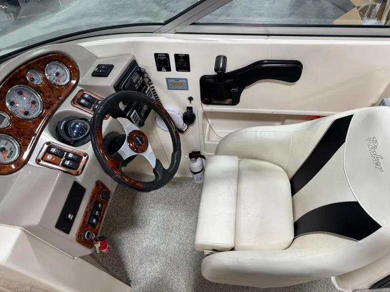 Slide: The Image of 2005 Rinker 282 Captiva Bowrider cockpit with steering wheel and control panel. - 10
