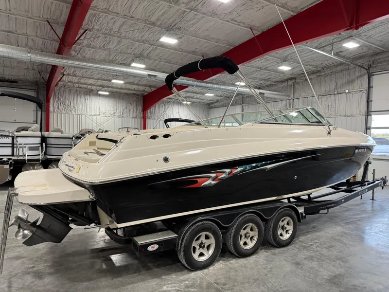 Slide: The Image of 2005 Rinker 282 Captiva Bowrider boat on trailer in indoor storage facility. - 4