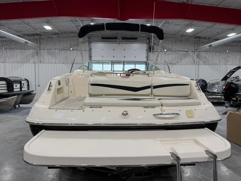 Slide: The Image of 2005 Rinker 282 Captiva Bowrider in a showroom, rear view with swim platform. - 5