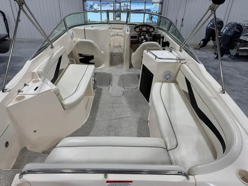 Slide: The Image of 2005 Rinker 282 Captiva Bowrider interior with white seating and dashboard view. - 6