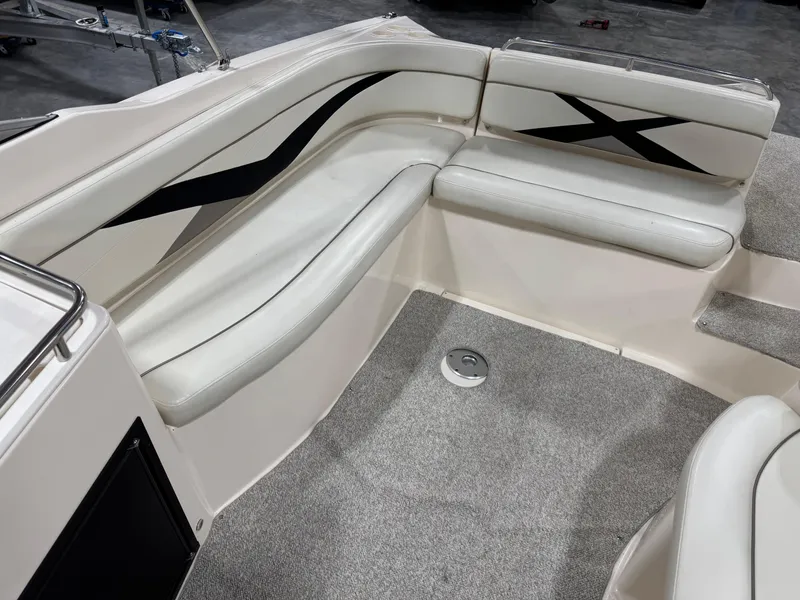 Slide: The Image of 2005 Rinker 282 Captiva Bowrider interior with white seating and black accents. - 7