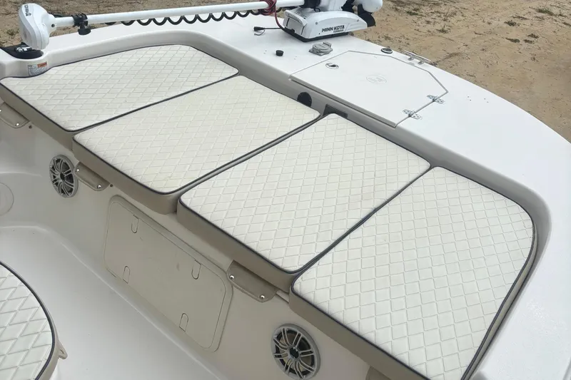 Slide: The Image of 2021 Carolina Skiff 19 LS boat interior with cushioned seating and storage compartments. - 7