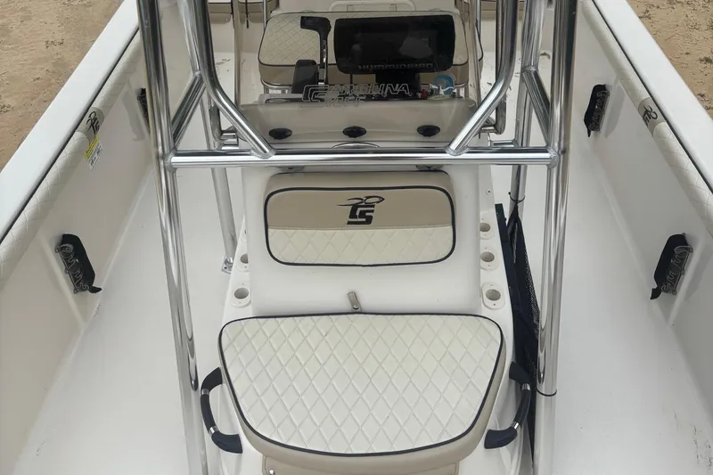 Slide: The Image of 2021 Carolina Skiff 19 LS boat interior with white seating and chrome details. - 8