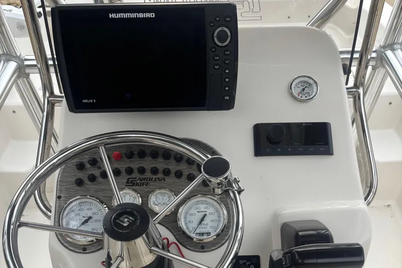 Slide: The Image of 2021 Carolina Skiff 19 LS dashboard with Humminbird electronics and steering wheel. - 9