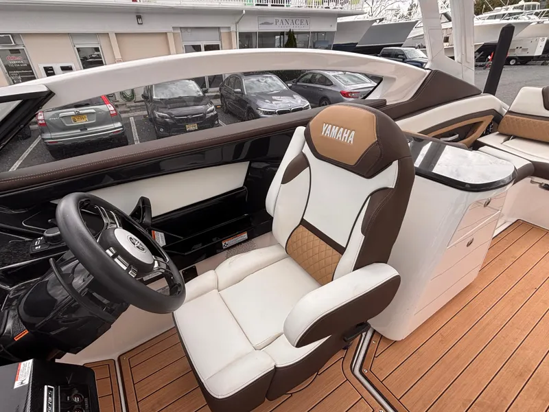Slide: The Image of 2021 Yamaha Boats 275 SD interior with luxurious seating and modern dashboard design. - 13