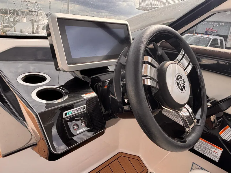 Slide: The Image of 2021 Yamaha Boats 275 SD helm with touchscreen display and steering wheel. - 16