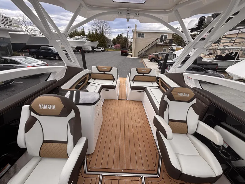Slide: The Image of 2021 Yamaha Boats 275 SD interior with luxurious seating and sleek design. - 17