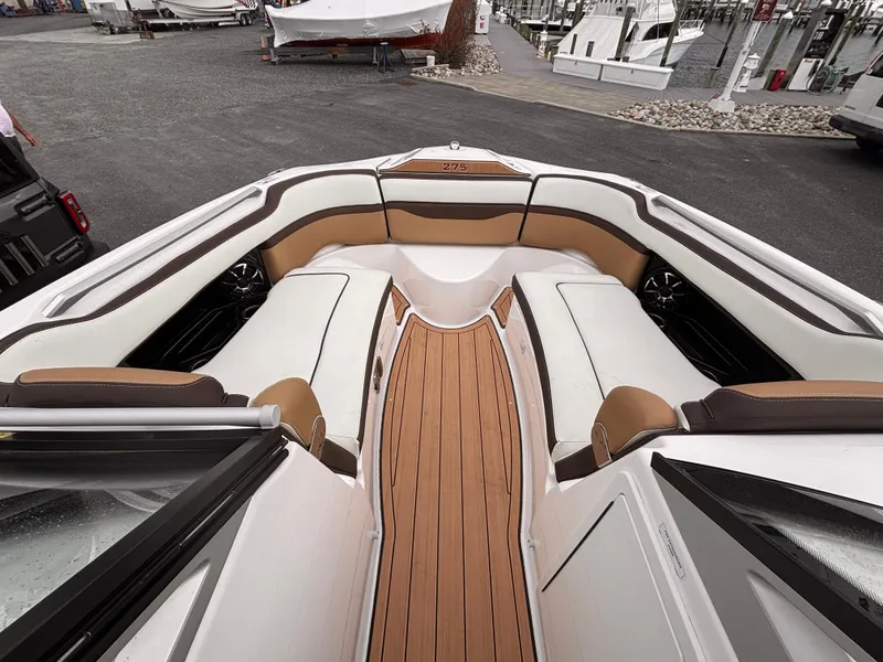 Slide: The Image of 2021 Yamaha Boats 275 SD interior with luxurious seating and sleek design. - 19