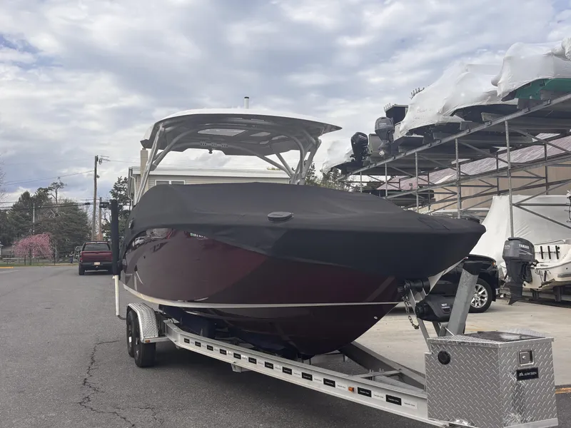 Slide: The Image of 2021 Yamaha Boats 275 SD on trailer, covered, parked outdoors under cloudy sky. - 5