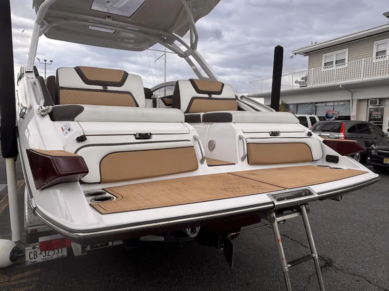 Slide: The Image of 2021 Yamaha Boats 275 SD with spacious deck and seating, docked at marina. - 6