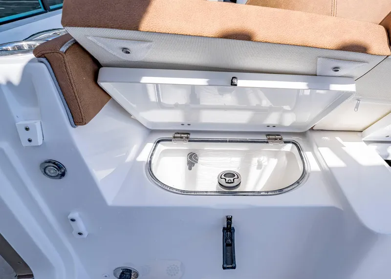 Slide: The Image of 2025 Sea Hunt Ultra 265 SE boat storage compartment with cushioned seating. - 12