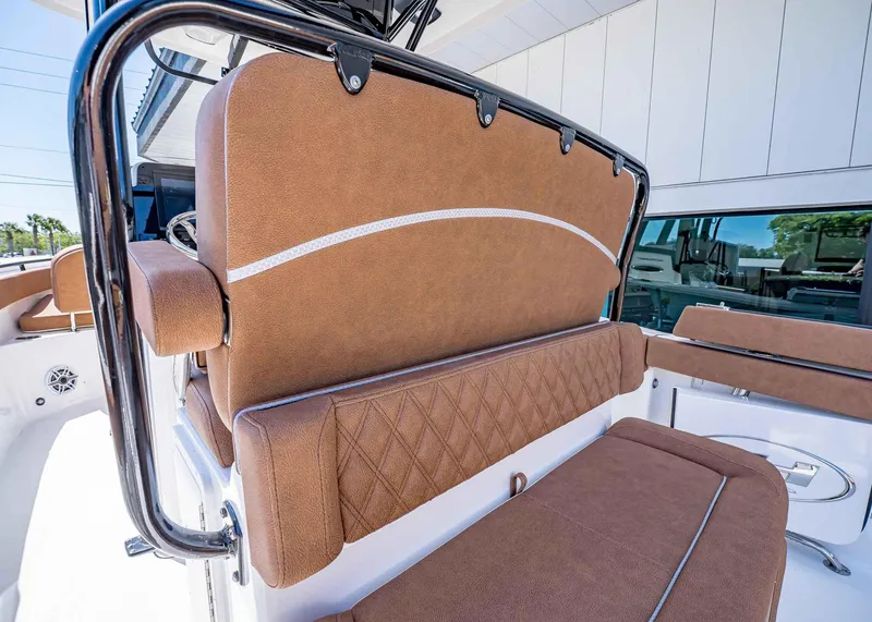 Slide: The Image of 2025 Sea Hunt Ultra 265 SE boat interior with brown cushioned seating and sleek design. - 18