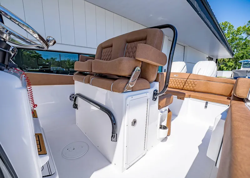 Slide: The Image of 2025 Sea Hunt Ultra 265 SE boat interior with luxurious brown seating and modern design. - 24