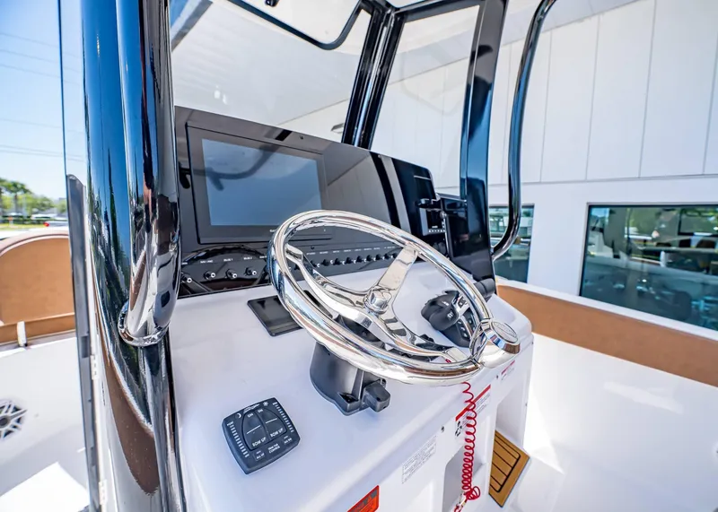 Slide: The Image of Steering console of 2025 Sea Hunt Ultra 265 SE boat with modern controls. - 29