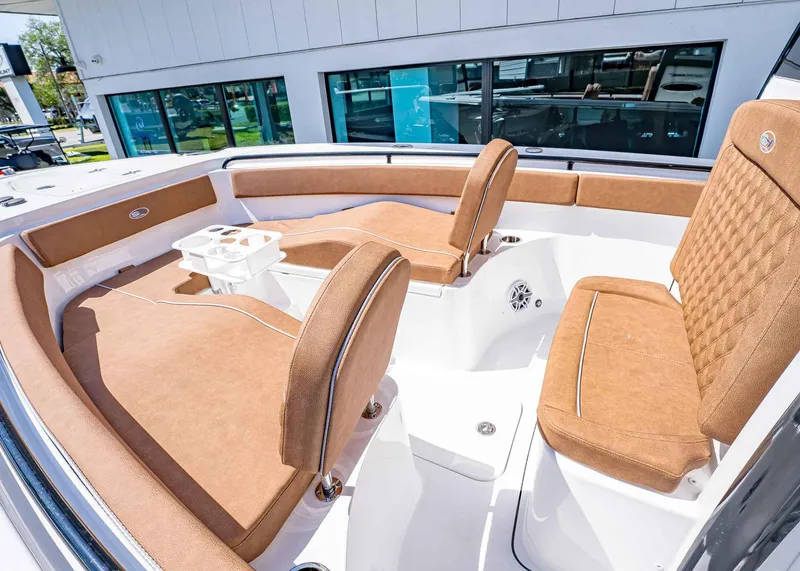 Slide: The Image of 2025 Sea Hunt Ultra 265 SE boat interior with tan seating and white deck. - 35