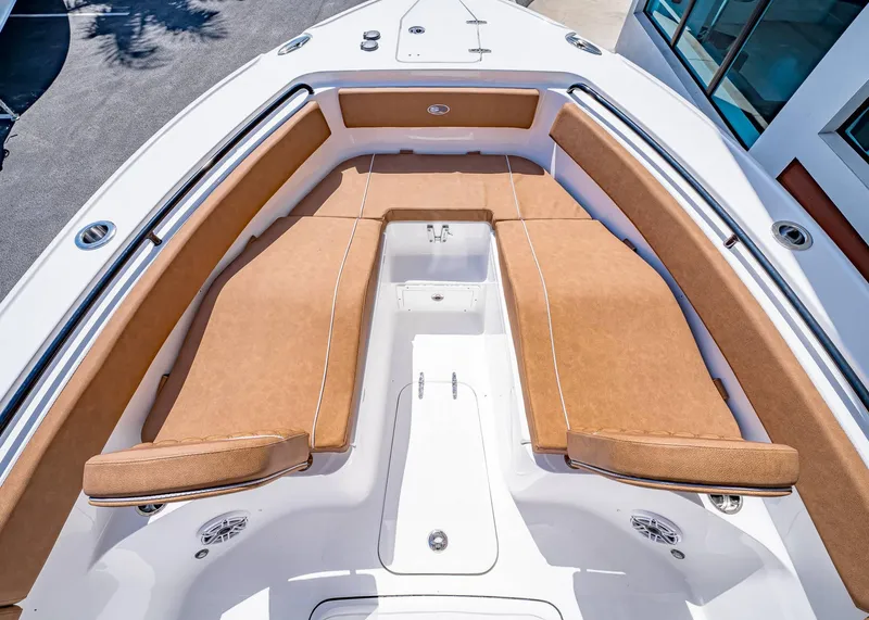 Slide: The Image of 2025 Sea Hunt Ultra 265 SE boat with tan cushioned seating and sleek white deck. - 37