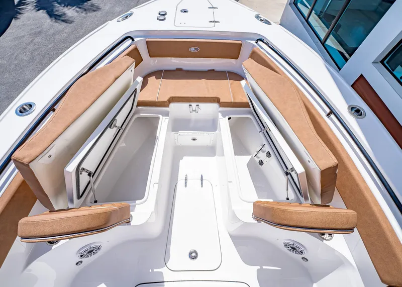 Slide: The Image of 2025 Sea Hunt Ultra 265 SE boat interior with tan seating and storage compartments. - 38