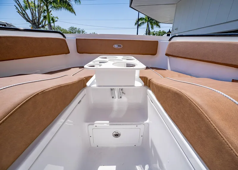 Slide: The Image of Interior of 2025 Sea Hunt Ultra 265 SE boat with cushioned seating and table. - 39