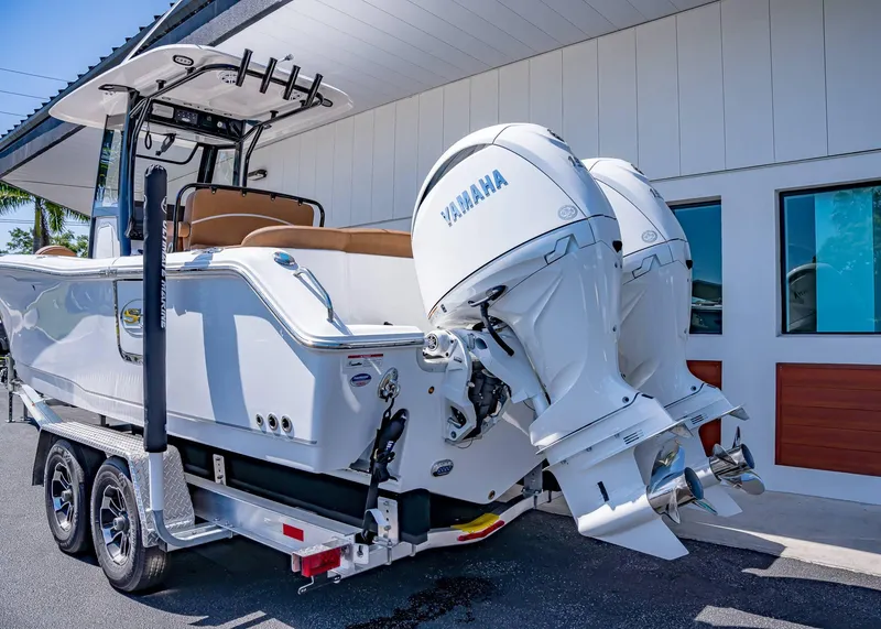 Slide: The Image of 2025 Sea Hunt Ultra 265 SE boat with dual Yamaha engines on a trailer. - 4