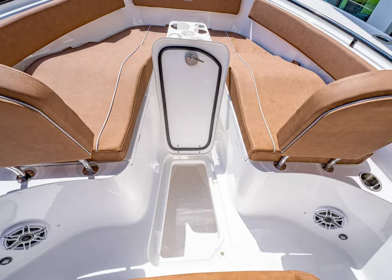 Slide: The Image of 2025 Sea Hunt Ultra 265 SE boat interior with tan seating and storage compartment. - 40