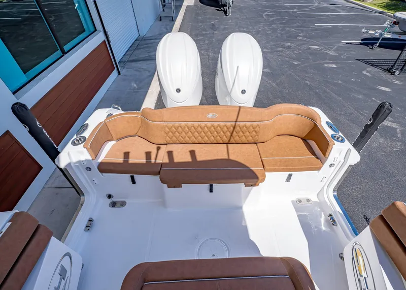 Slide: The Image of 2025 Sea Hunt Ultra 265 SE boat with tan seating and dual engines. - 6