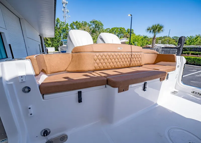 Slide: The Image of 2025 Sea Hunt Ultra 265 SE boat with tan cushioned seating and sleek design. - 7